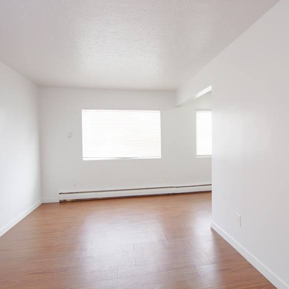 a room with wooden floors and a window.