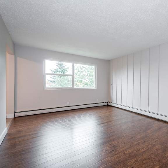 a room with wooden floors and white walls.