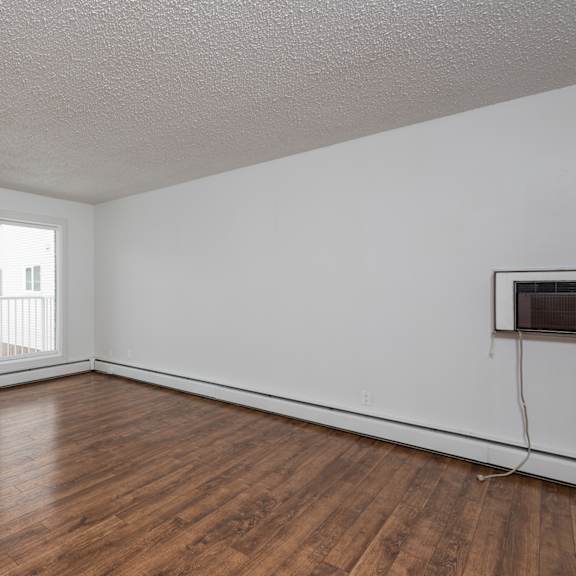 a room with wooden floors and a window.