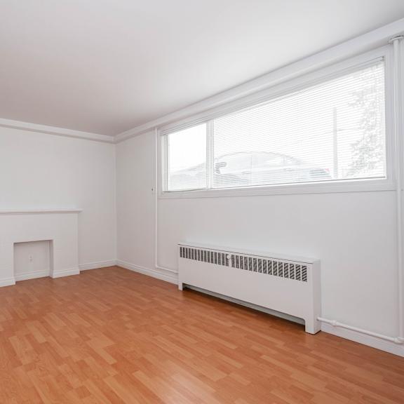a room with a fireplace and a window.