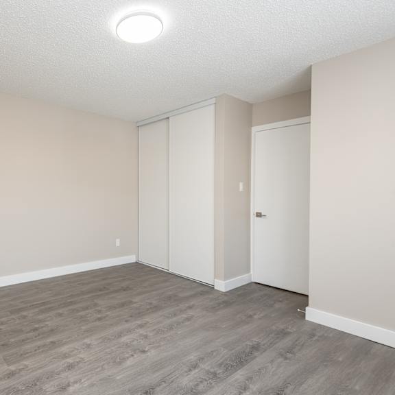 a room with a grey floor and white walls.