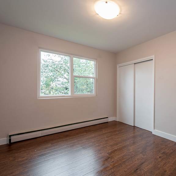 a room with a window and a closed door.