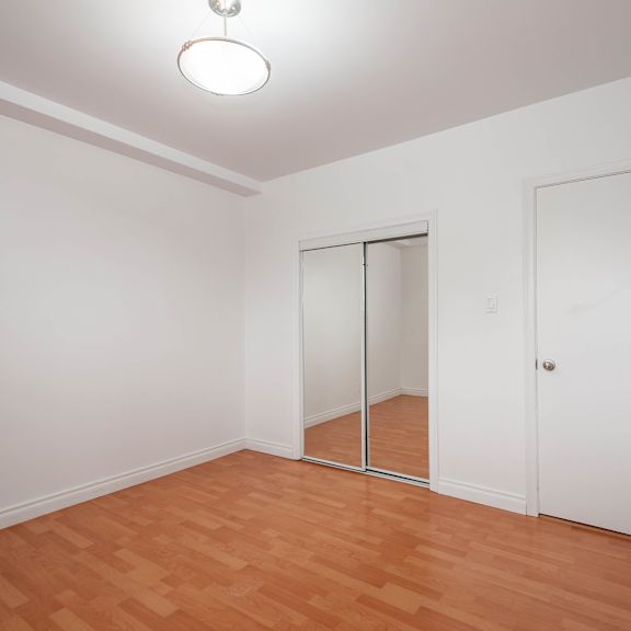 a room with a wooden floor and white walls.