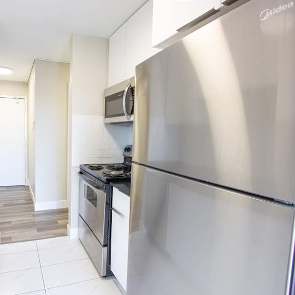 a modern kitchen with a stainless steel refrigerator.