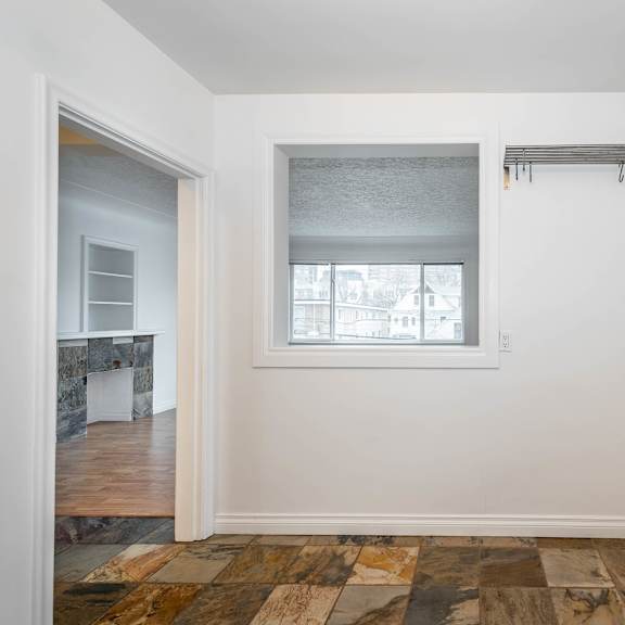 a room with a window and a radiator on the wall.