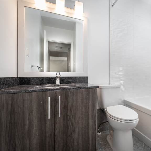 a white toilet sits next to a sink in a bathroom.