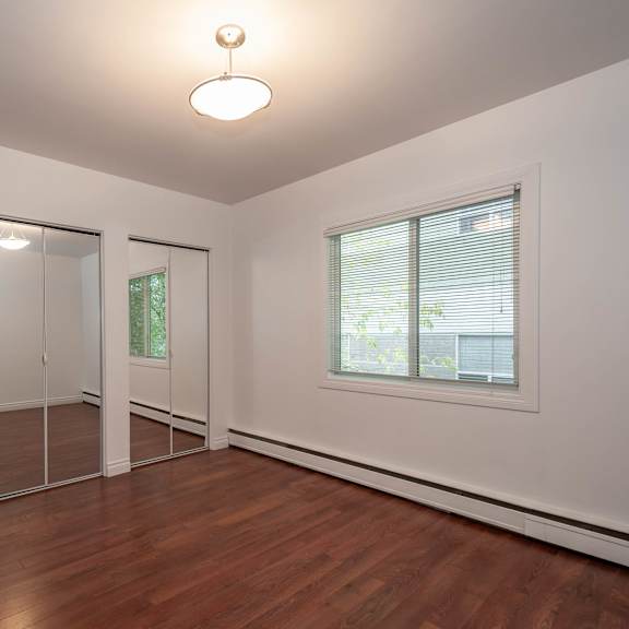 a room with a sliding glass door and a window.