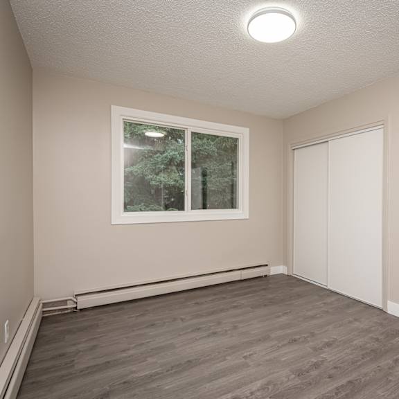 a room with a window and a closed door.