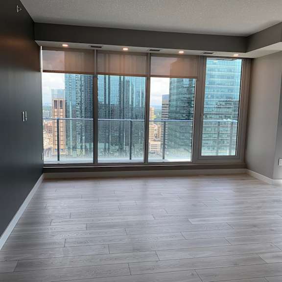 a room with a large window and a wooden wall.