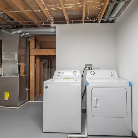 two large white appliances in a room under construction.