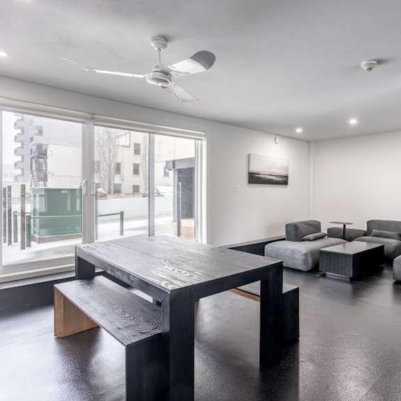 a room with a long table and chairs.