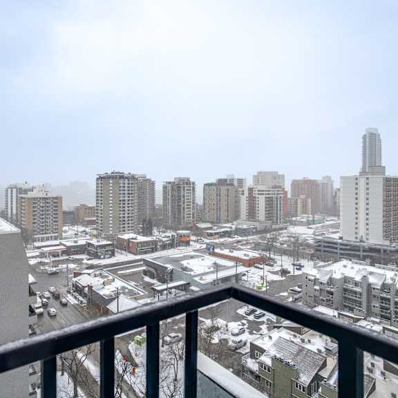 a cityscape with buildings and a snowy ground.