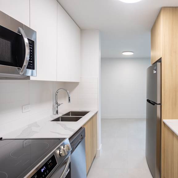 a modern kitchen with a stainless steel oven and microwave.