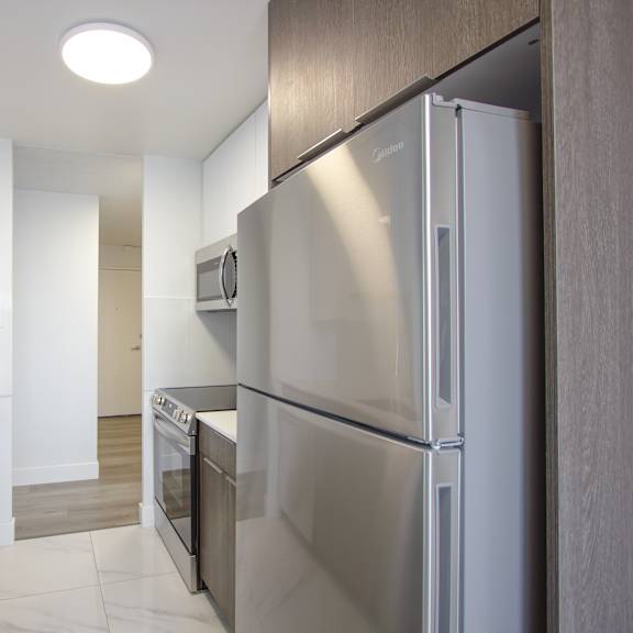 a modern kitchen with a stainless steel refrigerator.