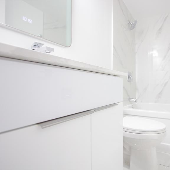 a white toilet sits next to a white bathtub in a bathroom.