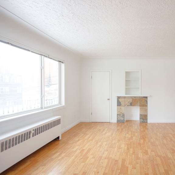 a room with wooden floors and white walls.