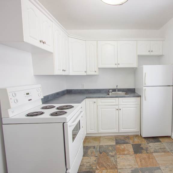 a kitchen with white appliances and cabinets.