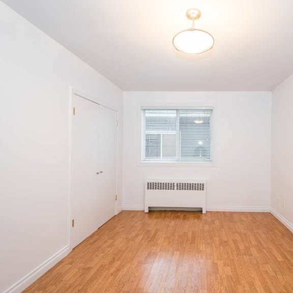 a room with a window and a radiator on the floor.