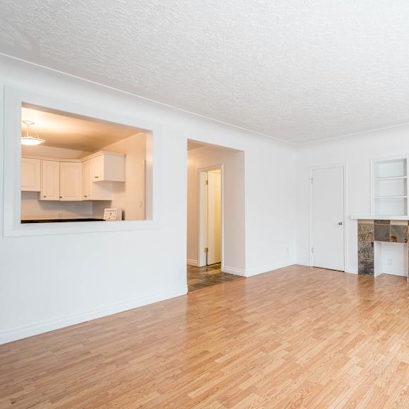 a room with wooden floors and white walls.