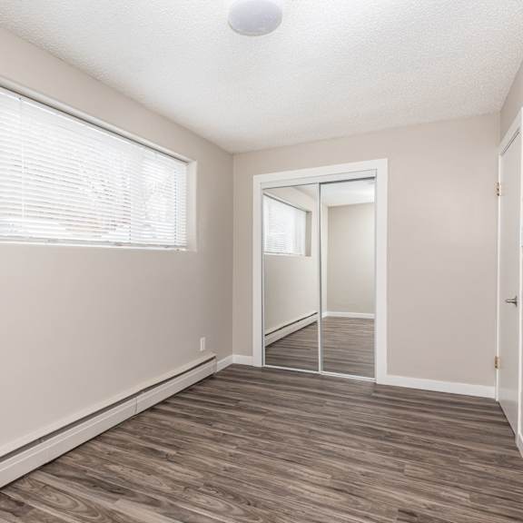a room with a sliding glass door and a wooden floor.