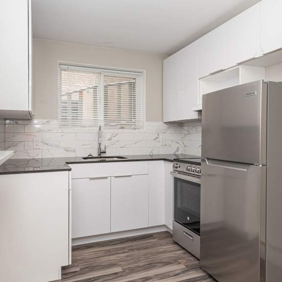 a modern kitchen with a stainless steel refrigerator.