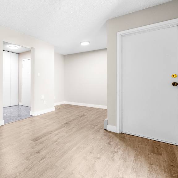 a room with a white door and a window with blinds.