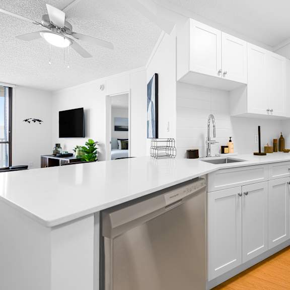 a modern kitchen with white cabinets and stainless steel appliances.