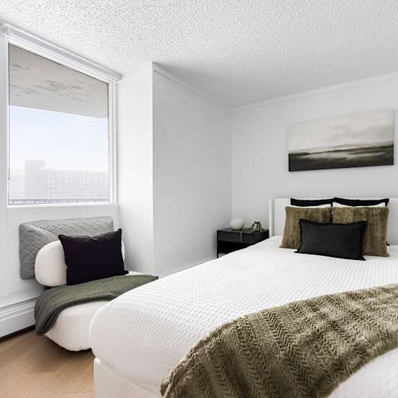 a bedroom with a large bed and a green blanket.