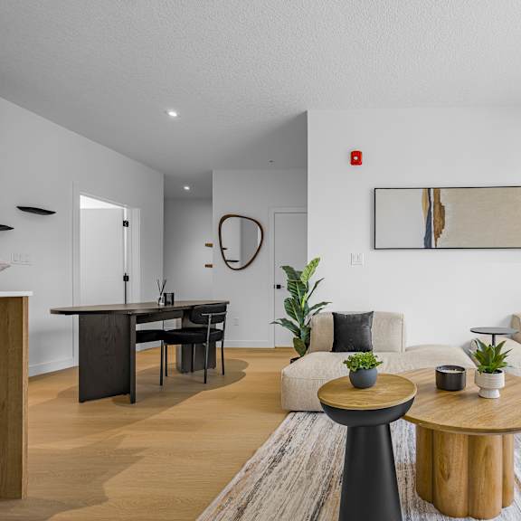 a modern living room with a wooden coffee table and a white sofa.