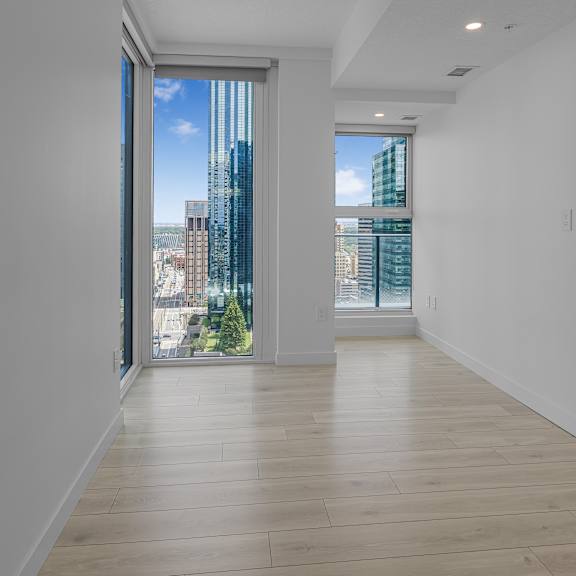 a long hallway with a view of the city outside the window.