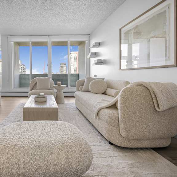 a modern living room with a large window and a flat screen tv mounted on the wall.