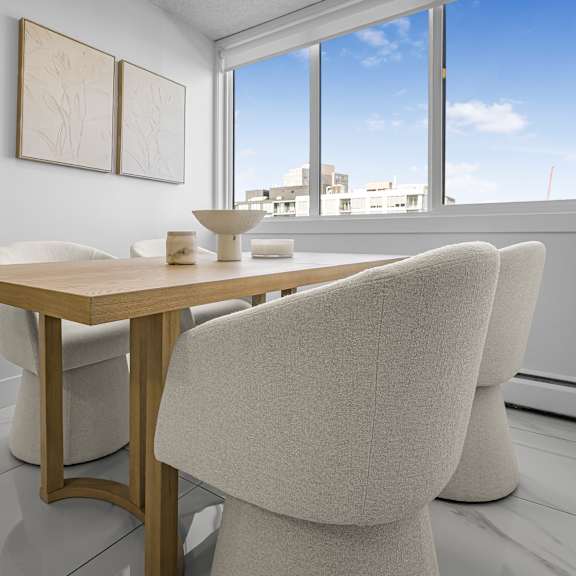 a dining room with a table and chairs.