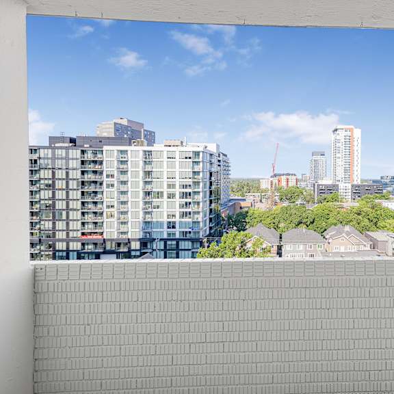 a view of a cityscape from a window with a white frame.