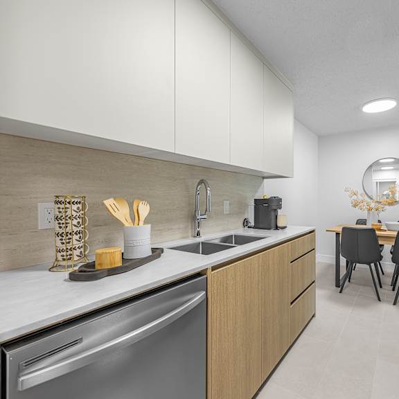 a modern kitchen with a dining table and chairs.