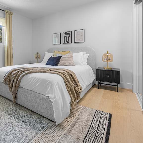 a bedroom with a large bed and a chair.