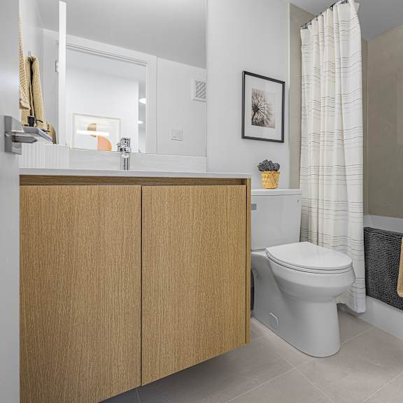 a white toilet sits in a bathroom next to a bathtub.