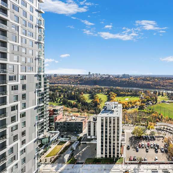 a view from a high-rise building looking down at a parking lot and other buildings.