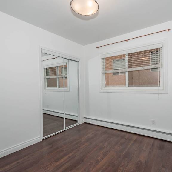 a room with a window and a wooden floor.