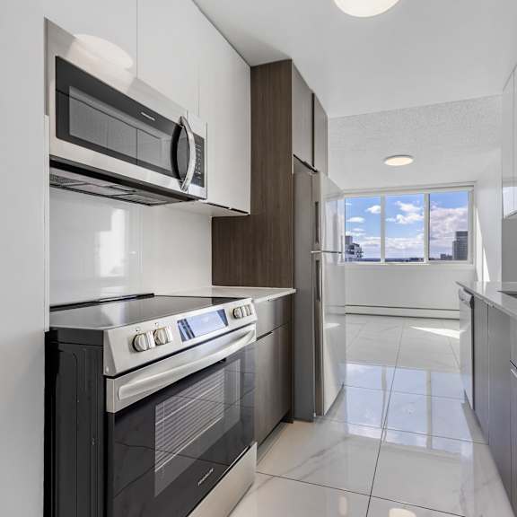 a modern kitchen with a white oven and microwave.