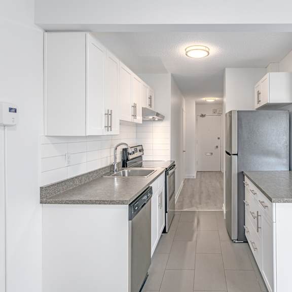 a kitchen with white cabinets and appliances.