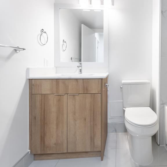 a white bathroom with a toilet, sink, and bathtub.