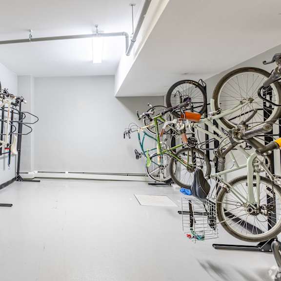 a bike rack with many bikes hanging on it.