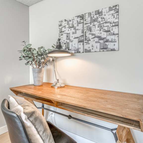 a table with a lamp and a plant on it.