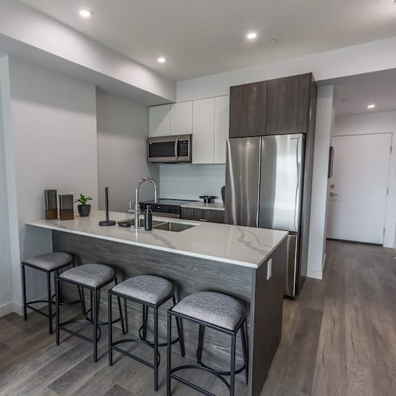 a modern kitchen with a bar stool.