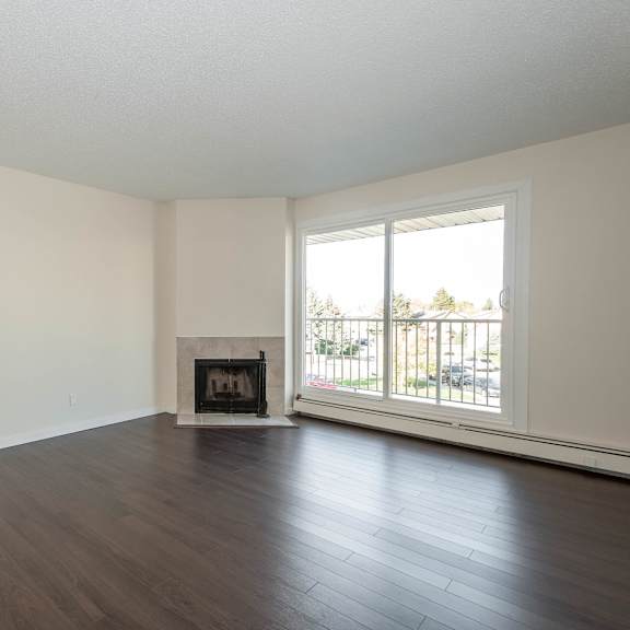 a living room with a fireplace and a sliding glass door.