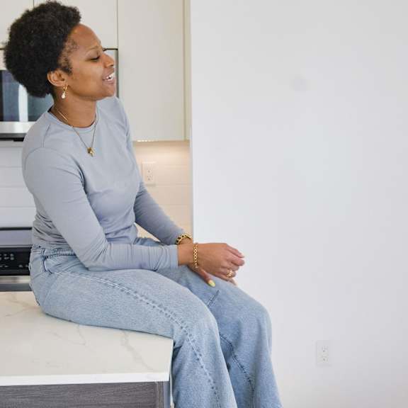 two women having a conversation in a kitchen.