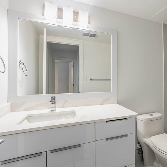 a white bathroom with a sink, toilet, and bathtub.