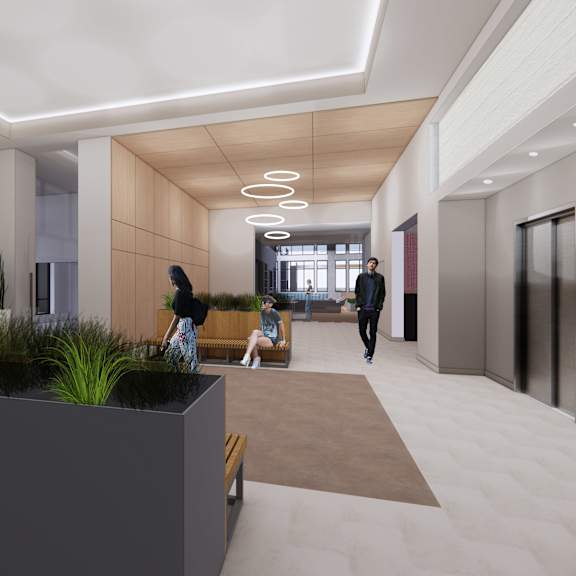 a modern hallway with people walking and sitting.