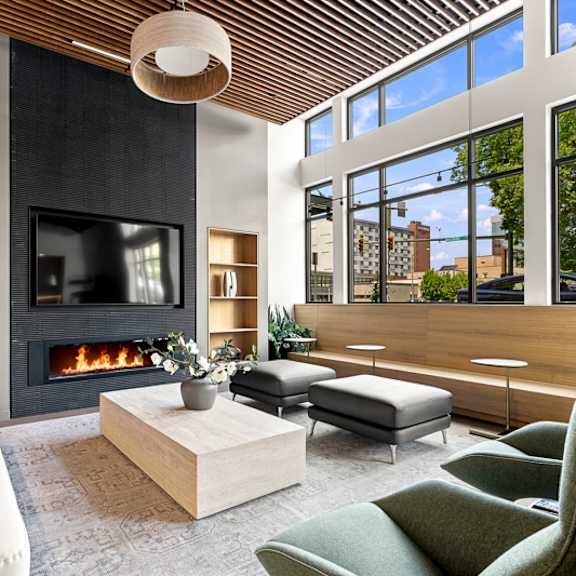 a modern living room with a fireplace and a large window.