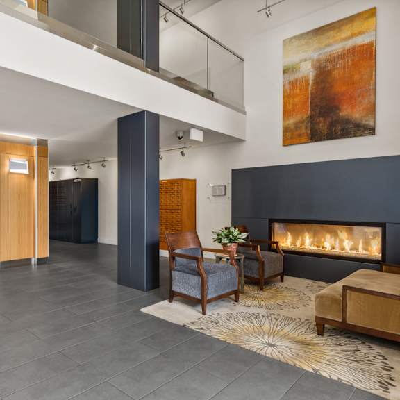 a modern living room with a fireplace and a painting on the wall.